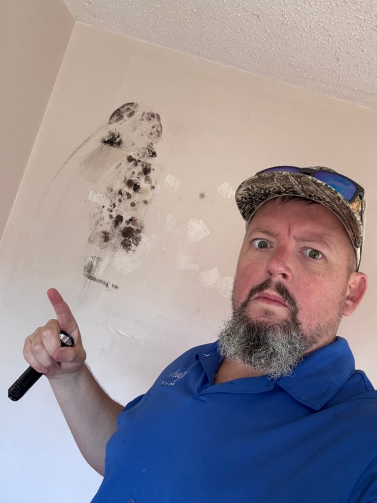Inspector collecting mold air sample indoors